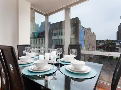 a dining room with a table with plates and wine glasses at Furnished Apartment near Rittenhouse Square apts in Philadelphia