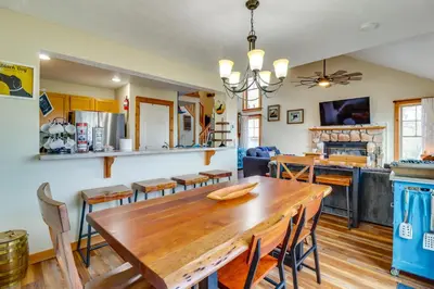 a kitchen and dining room with a wooden table and chairs at Tannersville Rental Near Camelback Ski Resort! in Tannersville