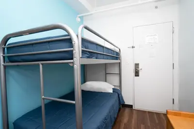 a bunk bed in a room with a blue wall at West Side YMCA in New York