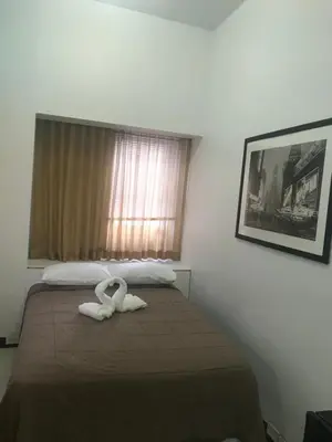 a bedroom with a bed with a white towel on it at West Side YMCA in New York
