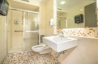 a bathroom with a sink and a toilet and a shower at West Side YMCA in New York