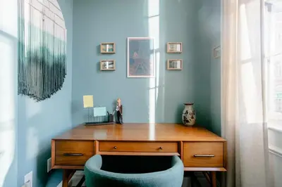 a wooden desk with a blue chair in a room at Airy Greenwich Retreat with Private Deck in New York