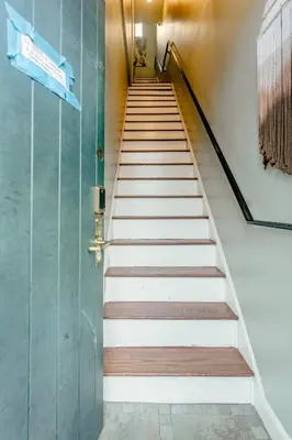 a set of stairs with a green door at Airy Greenwich Retreat with Private Deck in New York