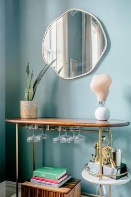 a mirror on top of a wooden shelf with books at Airy Greenwich Retreat with Private Deck in New York