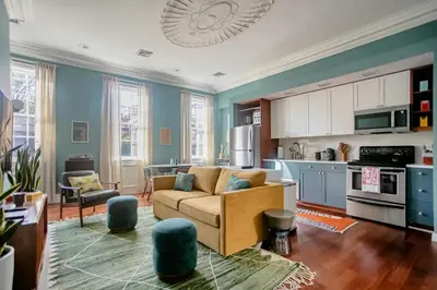 a living room with a couch and a kitchen at Airy Greenwich Retreat with Private Deck in New York