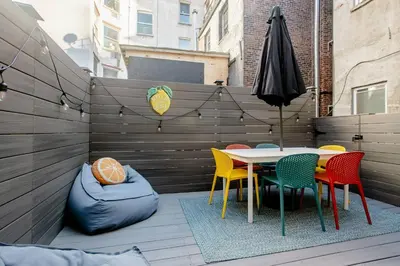 a patio with a table and chairs and an umbrella at Airy Greenwich Retreat with Private Deck in New York