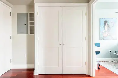 a white closet with a door in a room at Lofty & Bright Greenwich Getaway w Private Rooftop in New York
