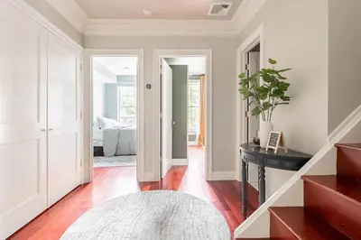a living room with white walls and wood floors at Lofty & Bright Greenwich Getaway w Private Rooftop in New York