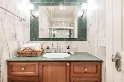 a bathroom with a sink and a mirror at Lofty & Bright Greenwich Getaway w Private Rooftop in New York