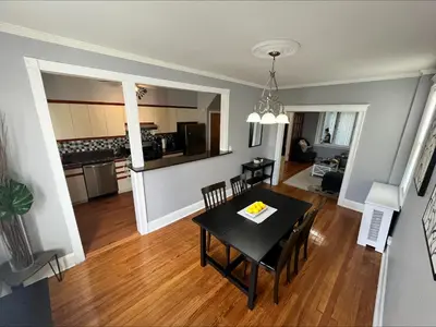 a dining room and kitchen with a table and chairs at Cozy Home close to New York City in Fairview