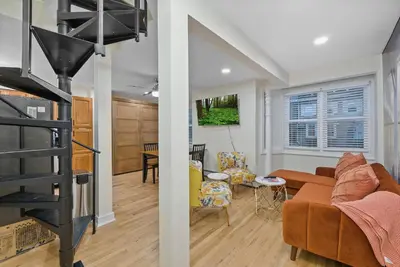 a living room and dining room with a fireplace at 10Min to NYC - 2BR/2.5Bath-3Beds-Free Parking-No Chores in Hoboken