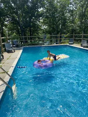 a man riding on an inflatable at Lakefront, Pool, Hot Tub, Boats, Game Room, Pets in Bushkill
