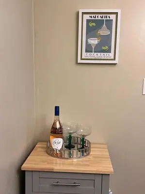 a bottle of wine and glasses on a table at Cozy on the Hill in Wilmington
