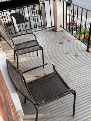 two benches on a deck with leaves on it at Cozy on the Hill in Wilmington