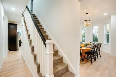 a staircase leading up to a dining room with a table at Family-Friendly Hatfield Home 3 Mi to Downtown! in Hatfield