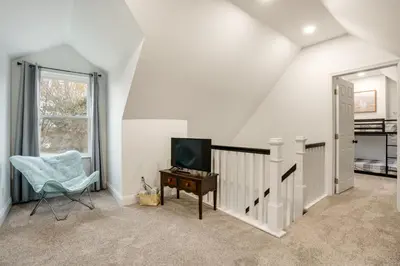 a living room with a tv and a chair at Family-Friendly Hatfield Home 3 Mi to Downtown! in Hatfield