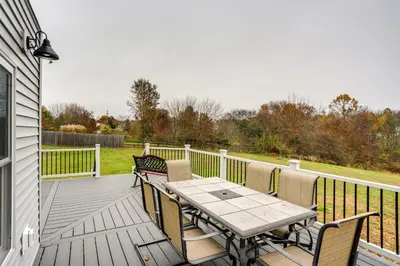 a wooden deck with a table and chairs on a house at Family-Friendly Hatfield Home 3 Mi to Downtown! in Hatfield