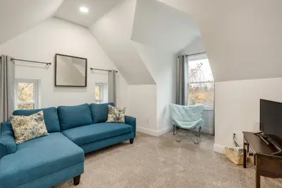 a living room with a blue couch and a television at Family-Friendly Hatfield Home 3 Mi to Downtown! in Hatfield