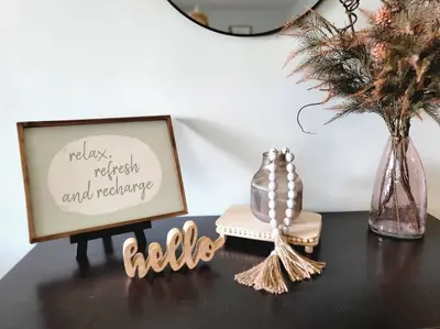 a black table with a picture and a vase with a plant at Home away from home in Pottstown