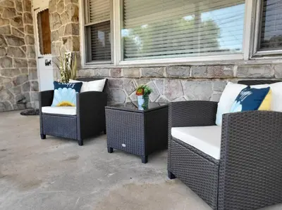 three wicker chairs and a table on a porch at Home away from home in Pottstown