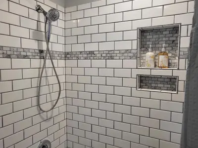a white tiled shower with a hose in a bathroom at Home away from home in Pottstown