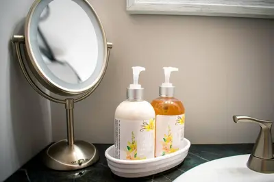 a bathroom sink with a mirror and two soap bottles at Home away from home in Pottstown
