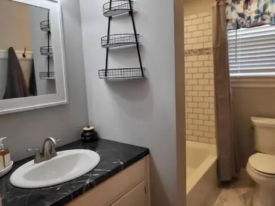 a bathroom with a sink and a toilet and a mirror at Home away from home in Pottstown