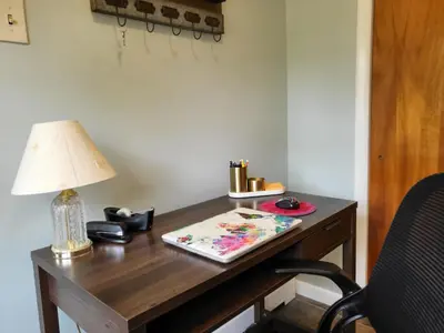 a desk with a lamp on top of it at Home away from home in Pottstown