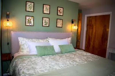 a bedroom with a bed with four pillows on it at Home away from home in Pottstown
