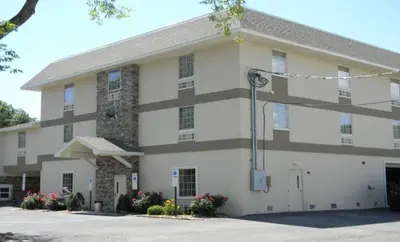 a large white building with a lot of windows at Gamble Farm Inn and Suites in Jersey Shore