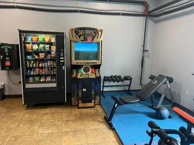 a room with a gym with a soda machine at Gamble Farm Inn and Suites in Jersey Shore