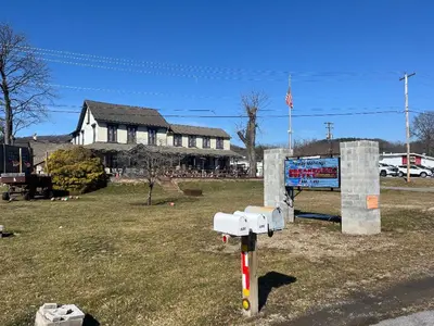 a parking meter in a field in front of a house at Gamble Farm Inn and Suites in Jersey Shore