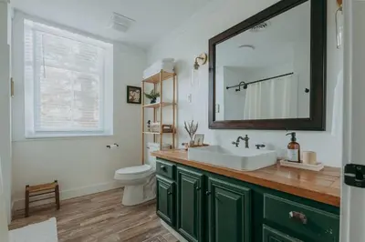 a bathroom with a sink and a toilet and a mirror at 1900's Historic Lancaster School House in Willow Street