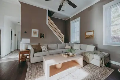 a living room with a couch and a table at 1900's Historic Lancaster School House in Willow Street