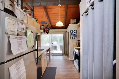 a kitchen with a refrigerator and a counter at Weekend at Bernie's! *Pet friendly!* **Hot tub** in Long Pond