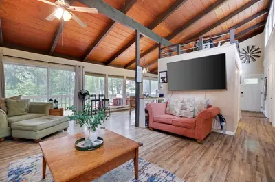 a living room with a tv and a couch and a table at Weekend at Bernie's! *Pet friendly!* **Hot tub** in Long Pond