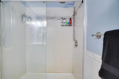 a bathroom with a shower with a glass door at Weekend at Bernie's! *Pet friendly!* **Hot tub** in Long Pond