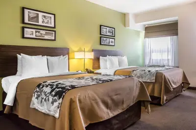 a hotel room with two beds and a window at Sleep Inn Philadelphia Center City in Philadelphia