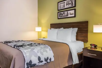 a hotel room with a bed with white pillows at Sleep Inn Philadelphia Center City in Philadelphia