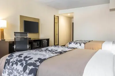 a hotel room with two beds and a flat screen tv at Sleep Inn Philadelphia Center City in Philadelphia