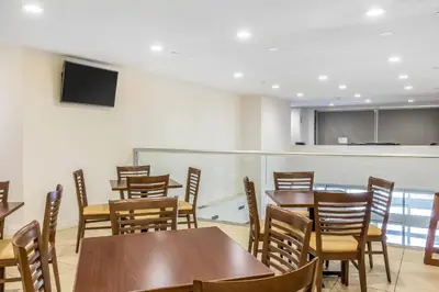 a dining room with wooden tables and chairs at Sleep Inn Philadelphia Center City in Philadelphia
