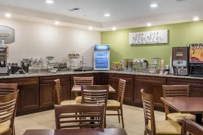 a restaurant with a counter and tables and chairs at Sleep Inn Philadelphia Center City in Philadelphia