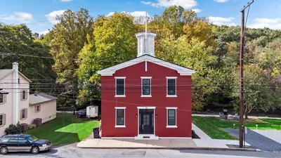 a red house with a white tower on a street at Riverview in Port Clinton - Apt A in Port Clinton
