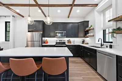 a kitchen with black cabinets and white countertops at Riverview in Port Clinton - Apt A in Port Clinton