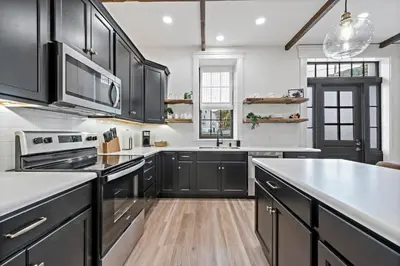 a kitchen with black cabinets and a white counter top at Riverview in Port Clinton - Apt A in Port Clinton
