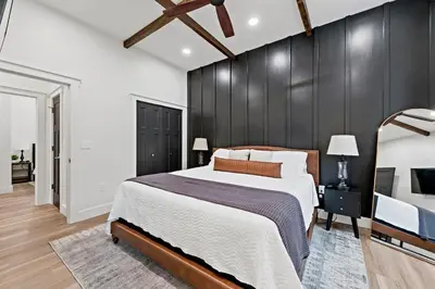 a bedroom with a large bed and a black wall at Riverview in Port Clinton - Apt A in Port Clinton
