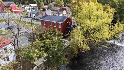an aerial view of a red house next to a river at Riverview in Port Clinton - Apt A in Port Clinton