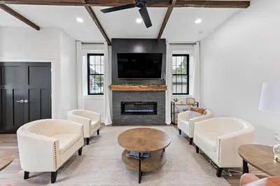 a living room with white furniture and a fireplace at Riverview in Port Clinton - Apt A in Port Clinton