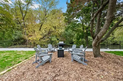 a group of chairs and a table under a tree at Riverview in Port Clinton - Apt A in Port Clinton