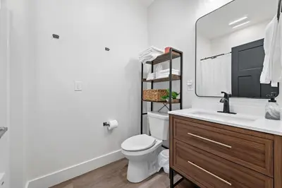 a bathroom with a sink and a toilet and a mirror at Riverview in Port Clinton - Apt. B in Port Clinton